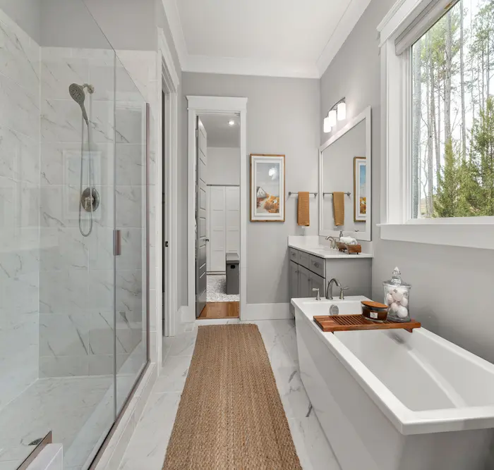 Spa-style primary bathroom renovation in a Scarsdale estate featuring freestanding tub and curbless shower